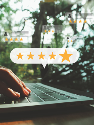 Person on laptop leaving a 5 City Finance Bank Google review